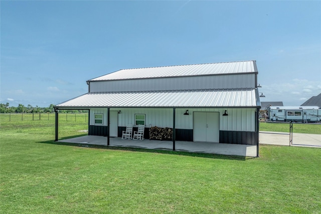 450 County Road 2411, Valley View, TX 76272 - back of house with metal roof, a yard, board and batten siding, and a patio area