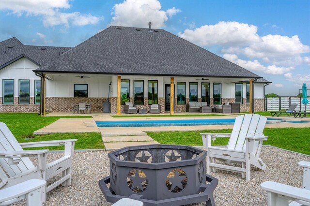 450 County Road 2411, Valley View, TX 76272 - back of property with a shingled roof, a ceiling fan, an outdoor living space with a fire pit, and an outdoor pool