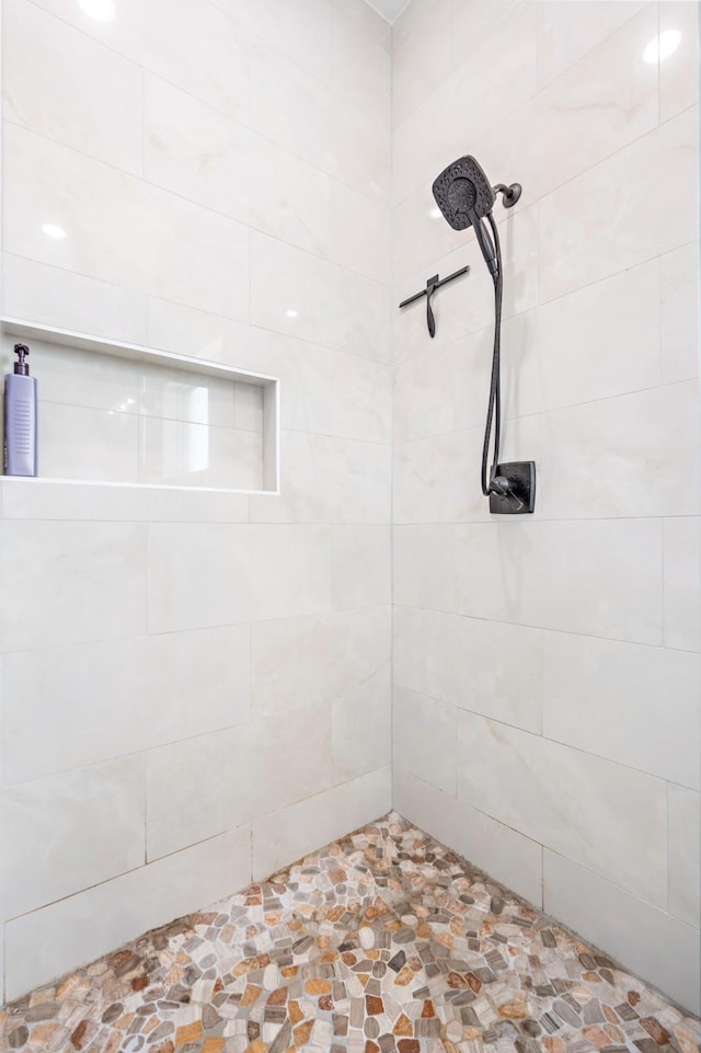 bathroom with a tile shower