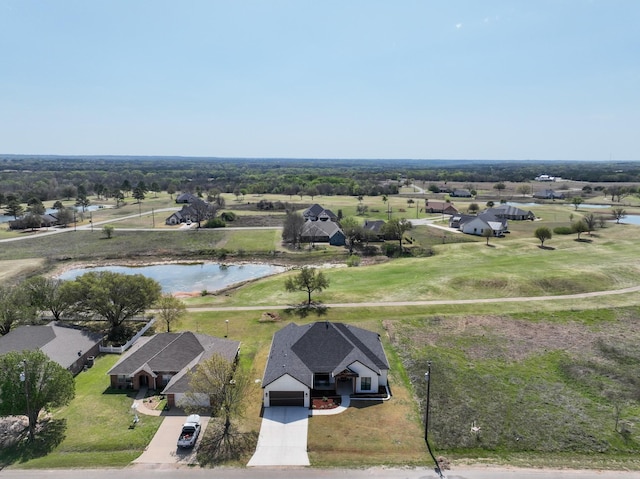 drone / aerial view featuring a residential view and a water view