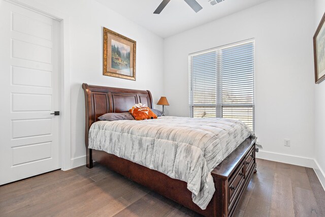 bedroom featuring visible vents, dark wood-style flooring, a ceiling fan, and baseboards