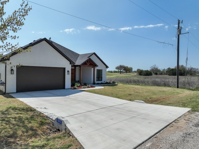 ranch-style home featuring a garage, stucco siding, driveway, and a front yard