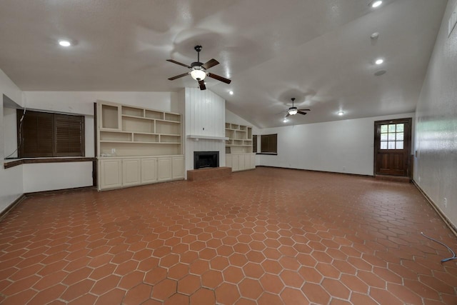 unfurnished living room featuring baseboards, a large fireplace, ceiling fan, and lofted ceiling