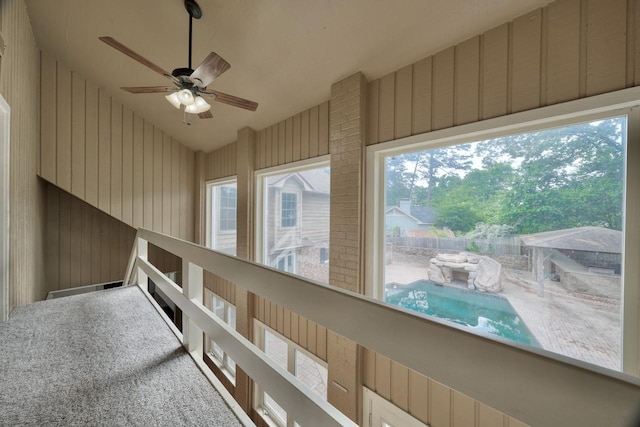 hallway featuring high vaulted ceiling and a healthy amount of sunlight