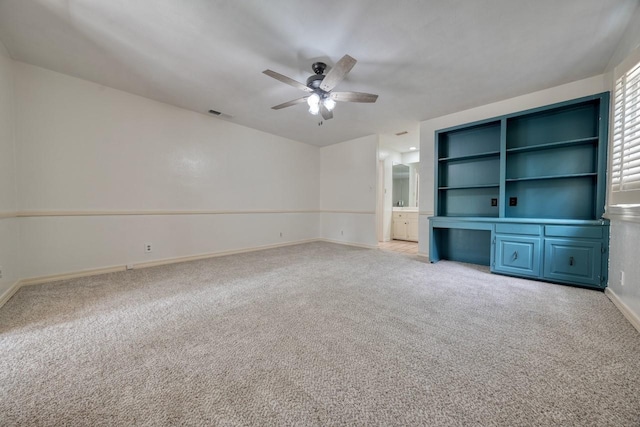 unfurnished living room with light colored carpet, visible vents, a ceiling fan, and baseboards