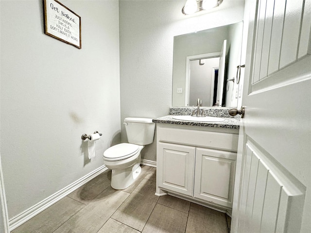 2811 W Washington St, Denison, TX 75020 - half bath with baseboards, toilet, and vanity