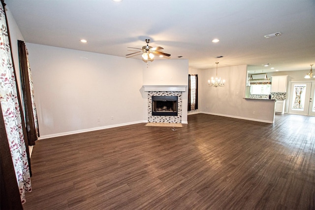 2811 W Washington St, Denison, TX 75020 - unfurnished living room with a tile fireplace, visible vents, recessed lighting, and ceiling fan with notable chandelier