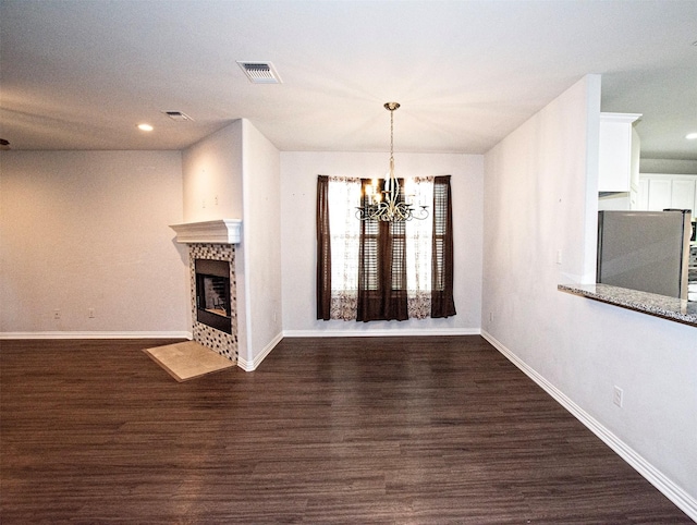 2811 W Washington St, Denison, TX 75020 - unfurnished living room with dark wood-style floors, visible vents, and baseboards