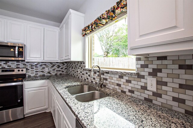 2811 W Washington St, Denison, TX 75020 - kitchen with appliances with stainless steel finishes, white cabinets, and a sink