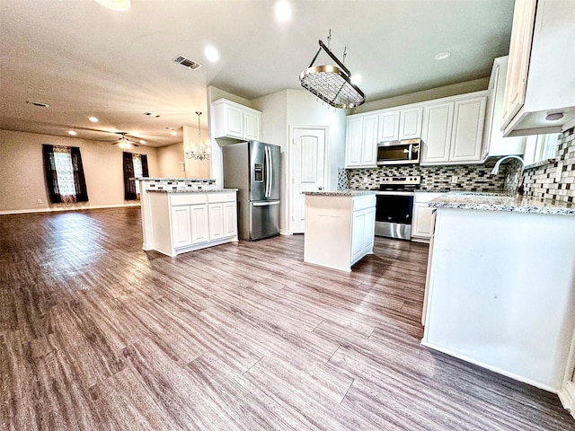 2811 W Washington St, Denison, TX 75020 - kitchen featuring a sink, appliances with stainless steel finishes, visible vents, open floor plan, and backsplash