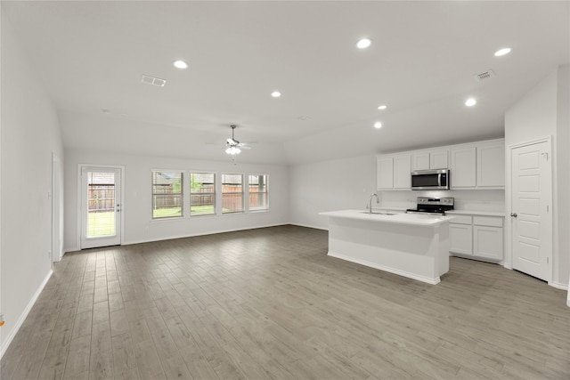 3246 Baehr, Royse City, TX 75189 - kitchen featuring stainless steel appliances, a ceiling fan, open floor plan, light wood-style floors, and white cabinets
