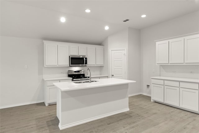 3246 Baehr, Royse City, TX 75189 - kitchen featuring stainless steel appliances, a kitchen island with sink, light countertops, light wood-type flooring, and white cabinets