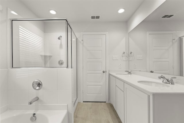 3246 Baehr, Royse City, TX 75189 - bathroom featuring a stall shower, a bathtub, double vanity, wood finished floors, and recessed lighting