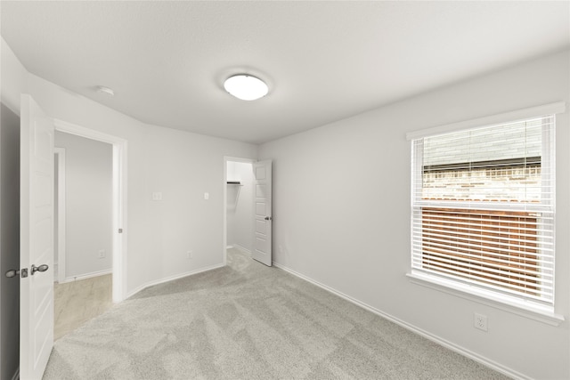 3246 Baehr, Royse City, TX 75189 - unfurnished bedroom featuring carpet flooring, a walk in closet, and a closet