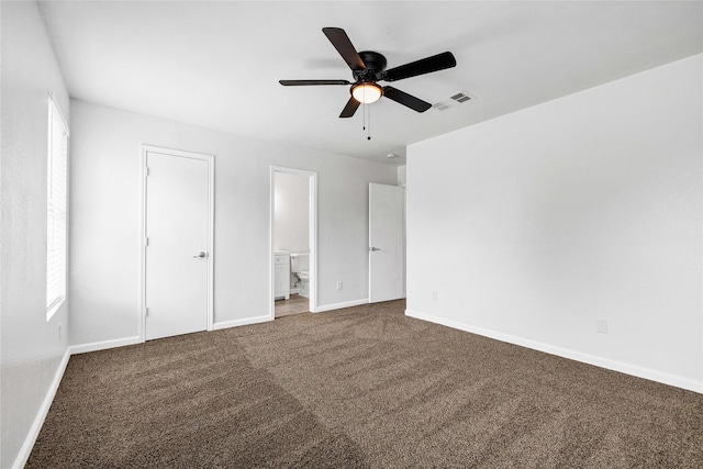 unfurnished bedroom with connected bathroom, ceiling fan, visible vents, baseboards, and carpet floors