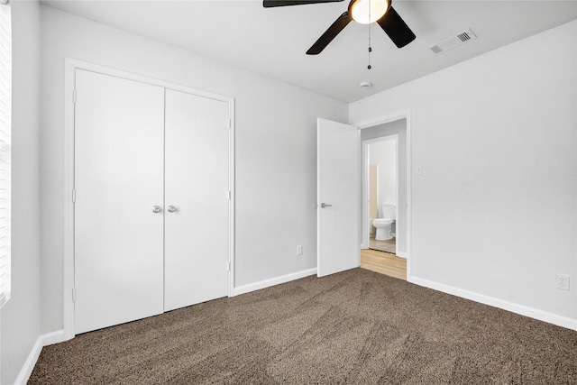 unfurnished bedroom with visible vents, a closet, baseboards, carpet floors, and a ceiling fan