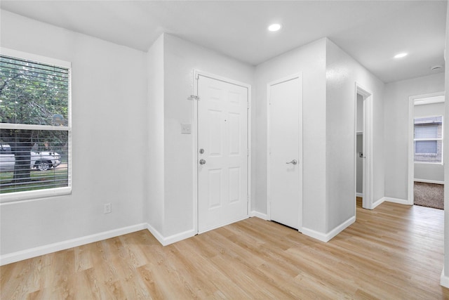 entrance foyer featuring light wood-type flooring, recessed lighting, and baseboards