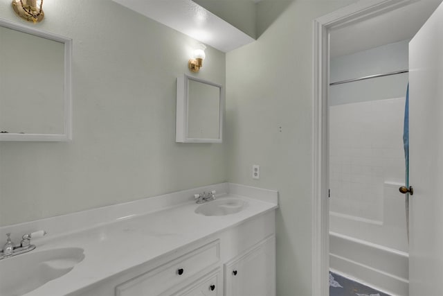 bathroom with double vanity, a sink, and shower / bathtub combination