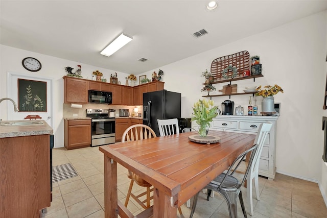 dining area with light tile patterned floors, visible vents, and recessed lighting