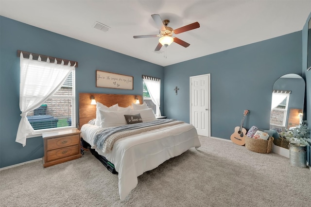 bedroom featuring visible vents, ceiling fan, light colored carpet, and baseboards