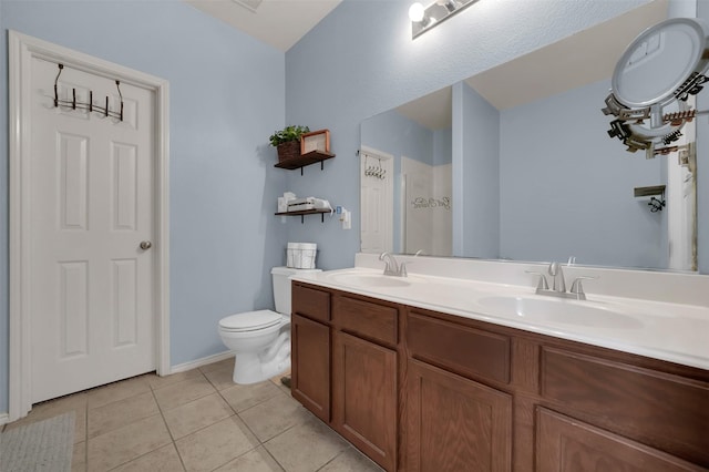 full bath with tile patterned floors, toilet, double vanity, and a sink