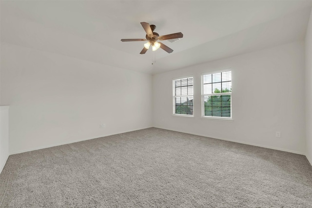 empty room with carpet, ceiling fan, and baseboards