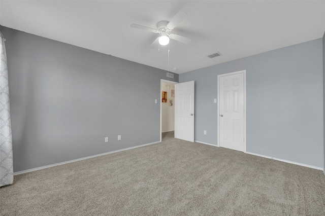 unfurnished bedroom with carpet, visible vents, a ceiling fan, and baseboards