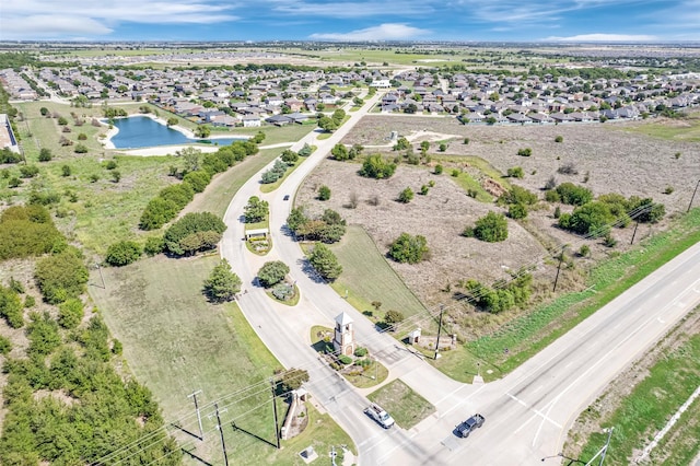 drone / aerial view featuring a residential view and a water view