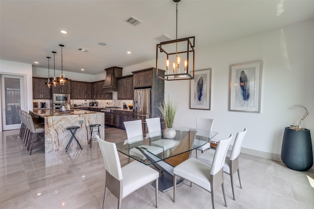 dining room with baseboards, visible vents, an inviting chandelier, and recessed lighting