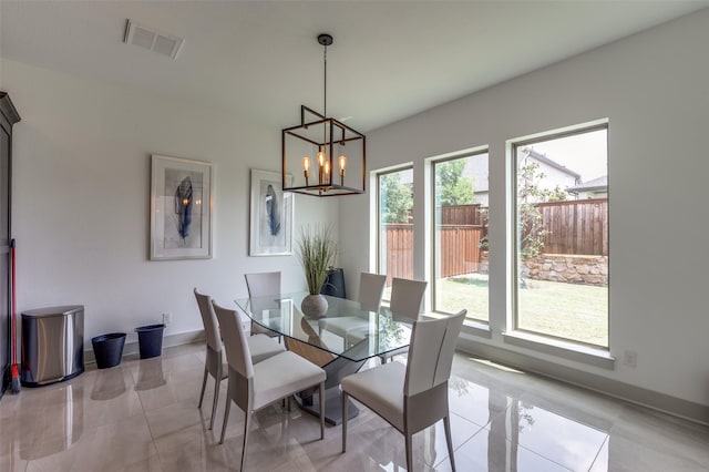 dining room featuring baseboards, visible vents, light tile patterned floors, and an inviting chandelier
