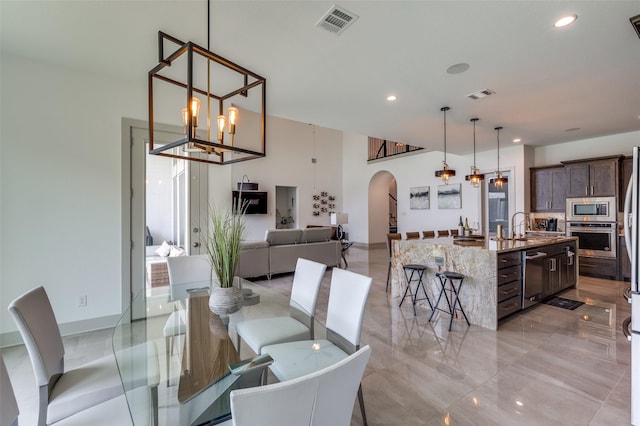 dining room featuring visible vents, recessed lighting, a notable chandelier, and arched walkways