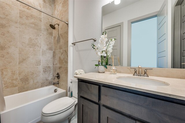 bathroom featuring toilet, tub / shower combination, and vanity