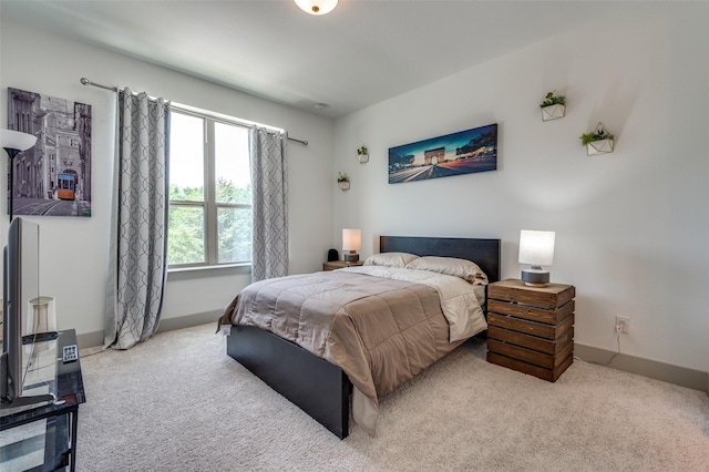 carpeted bedroom featuring baseboards
