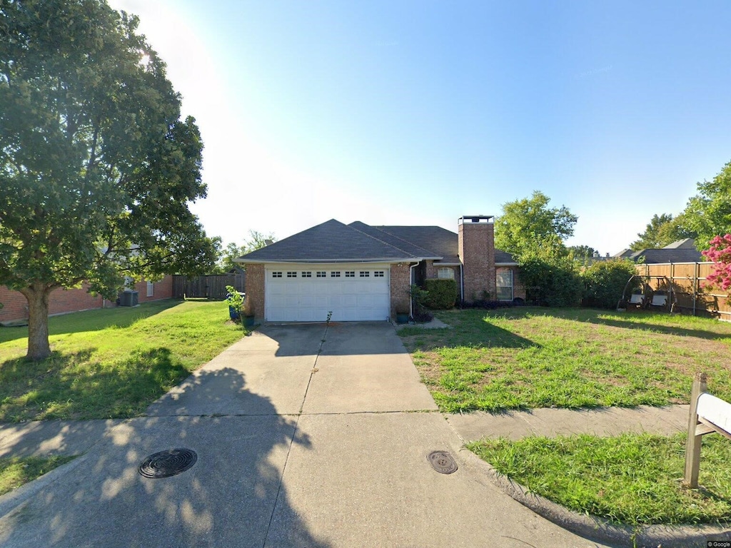 102 Marquette St, Forney, TX 75126 - ranch-style house featuring concrete driveway, a chimney, a front yard, brick siding, and a garage