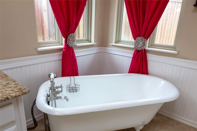 1515 Brighton Dr, Carrollton, TX 75007 - bathroom with a freestanding tub and wainscoting