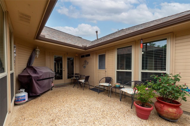 1515 Brighton Dr, Carrollton, TX 75007 - view of patio featuring a grill, french doors, and visible vents