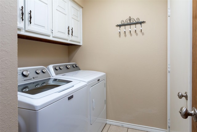 1515 Brighton Dr, Carrollton, TX 75007 - laundry area with light tile patterned floors, washing machine and clothes dryer, cabinet space, and baseboards