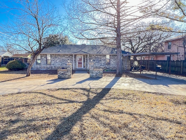 505 N Yosemite, Iowa Park, TX 76367 - view of front facade with fence, a carport, and concrete driveway