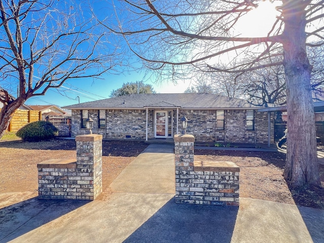 505 N Yosemite, Iowa Park, TX 76367 - view of front of house featuring roof with shingles, fence, and brick siding