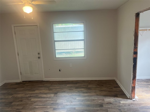 spare room with wood finished floors, ceiling fan, and baseboards