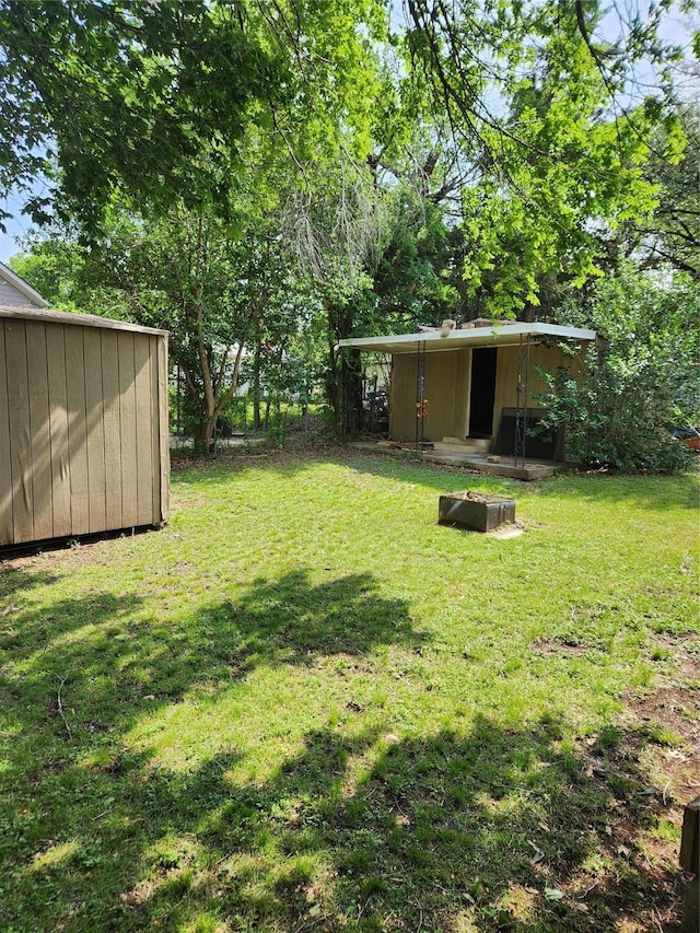 view of yard with an outdoor structure and a shed