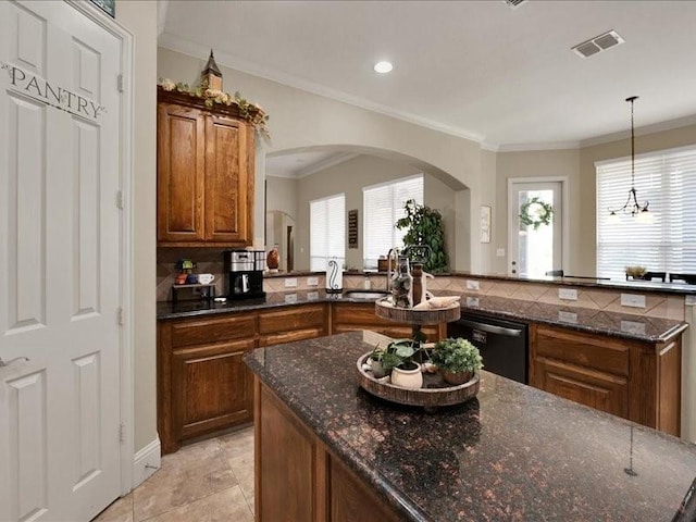 kitchen featuring arched walkways, brown cabinetry, ornamental molding, dishwasher, and visible vents