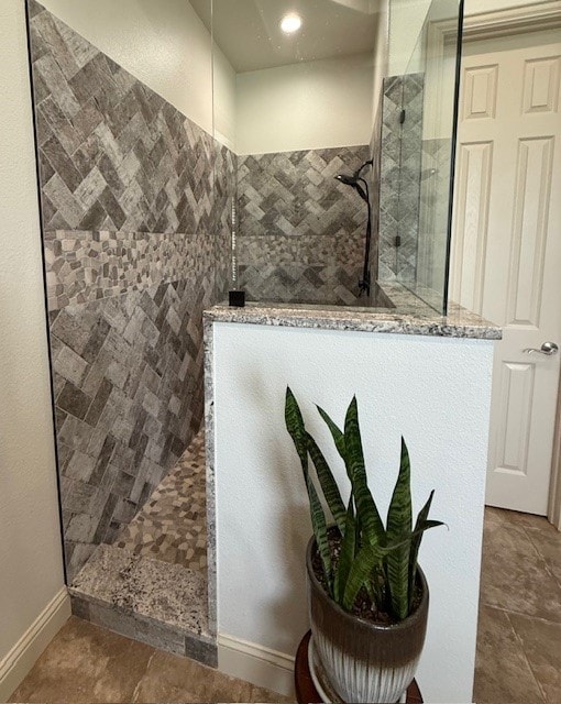 bathroom featuring baseboards and a walk in shower