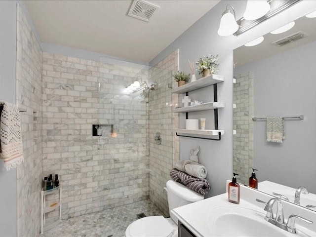 full bath featuring visible vents, tiled shower, toilet, and vanity