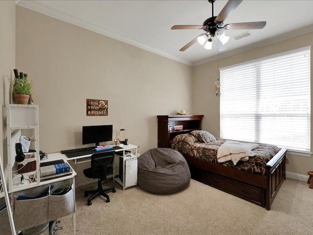 bedroom with crown molding, carpet flooring, visible vents, ceiling fan, and baseboards