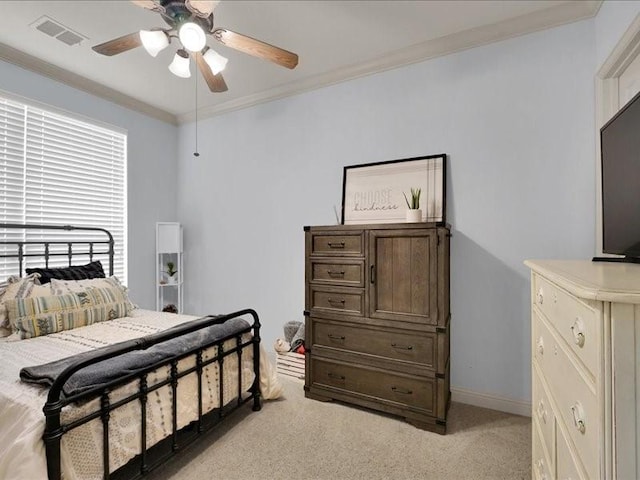 bedroom with ornamental molding, visible vents, light carpet, and baseboards