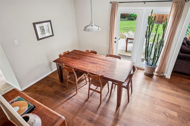 dining area featuring wood finished floors and baseboards