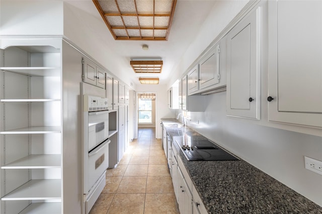 911 Prestwick Ln, Richardson, TX 75080 - kitchen with black electric cooktop, double oven, open shelves, and a sink