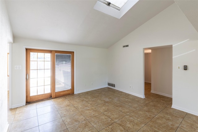 911 Prestwick Ln, Richardson, TX 75080 - unfurnished room featuring light tile patterned floors, visible vents, baseboards, and vaulted ceiling with skylight