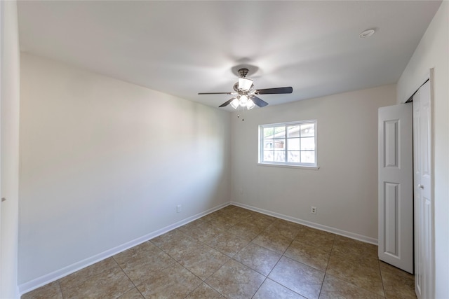 911 Prestwick Ln, Richardson, TX 75080 - unfurnished bedroom featuring light tile patterned flooring, ceiling fan, and baseboards